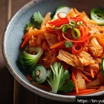 Home 23 채식 요리에서의 발효 음식 활용법 - A vibrant, close-up image of a traditional Korean kimchi salad served in a rustic ceramic bowl, feat...